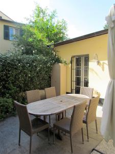 a wooden table and chairs on a patio at House in the convent in Chiavari
