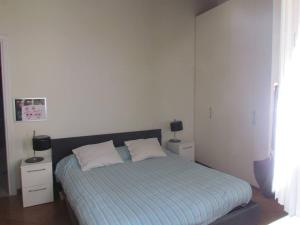 a bedroom with a bed with two pillows on it at House in the convent in Chiavari