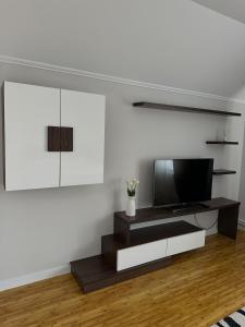 a living room with a flat screen tv on a wall at A quiet area in Durleşti