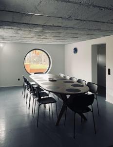 a table and chairs in a room with a large window at Casa Oblò in Mendrisio +56 photos