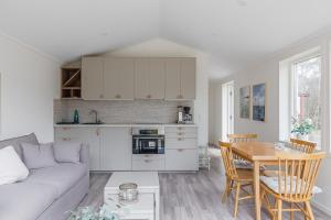 a living room with a couch and a table at Cozy 2BR Retreat by the Sea in Väddö