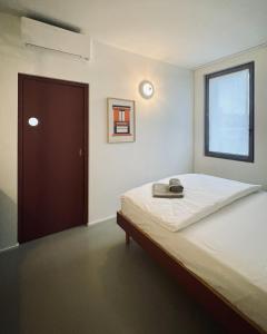 a bedroom with a bed and a window and a door at Casa Oblò in Mendrisio +54 photos