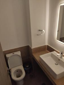 ein Badezimmer mit einer weißen Toilette und einem Waschbecken in der Unterkunft 3bedroom chalet swan lake north coast-388A in Zāwiyat al ‘Awwāmah