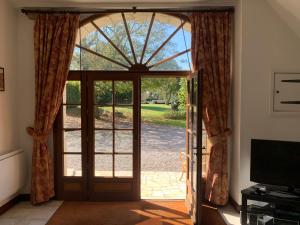 an open door with a view of a yard at Beautiful Big Home with Swimming Pool and Nature Grounds in Auterrive