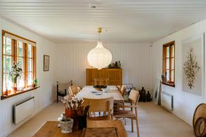 a dining room with a table and chairs at Thatched Hideaway At Svinkløv Forest Edge in Fjerritslev