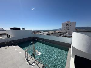 a swimming pool on the roof of a building at ICEBERG LUXURY DUNEs Free Private Parking in Tarifa