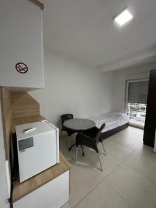a small room with a small table and a bed at Bakal in Gostivar