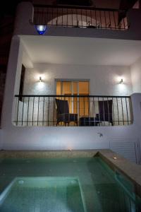 a house with a swimming pool in front of a balcony at Waterside Village in Luz