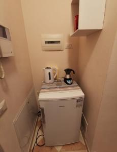 a small refrigerator with a coffee maker on top of it at Stanza Campori in Modena