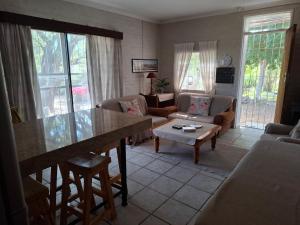 a living room with a table and a couch at Rietfontein farmstay in Prince Albert