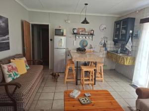 a living room with a table and a kitchen at Rietfontein farmstay in Prince Albert