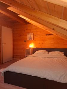 a bedroom with a bed in a wooden room at Innersoulhouse in Wuustwezel