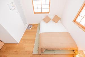 Postel nebo postele na pokoji v ubytování Kamakura no Nikki