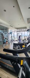 a gym with rows of treadmills and people in the background at centric sea pattaya中心海 in Pattaya Central
