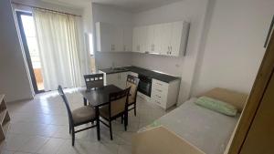 a kitchen and dining room with a table and chairs at Bledi's Apartment Spille in Spille