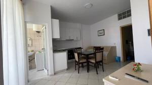 a kitchen and dining room with a table and chairs at Bledi's Apartment Spille in Spille