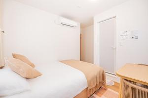 Postel nebo postele na pokoji v ubytování Kamakura no Nikki