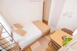 Postel nebo postele na pokoji v ubytování Kamakura no Nikki