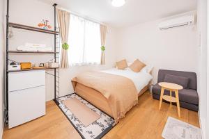 Postel nebo postele na pokoji v ubytování Kamakura no Nikki