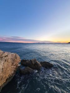 a group of rocks in the ocean at sunset at Old town hesed in Split