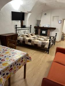a bedroom with a bed and a fireplace in a room at Casa Grande appartamento Marianna in Pragelato +9 photos