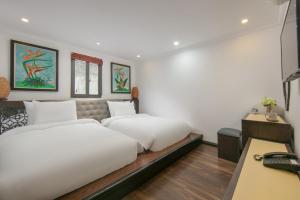 Postel nebo postele na pokoji v ubytování Quiet Sapa Hotel