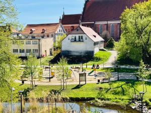 a group of people playing in a park next to a building at Mazurska in Barczewo