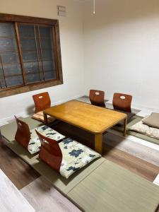 a room with a table and chairs and a window at Kame in Niseko