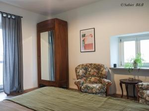 a bedroom with a bed and a chair and a window at Subiet B&B in Moncalvo +51 photos