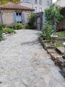 a stone driveway in front of a house at Villa Toscane in Saint-Germain-Lembron