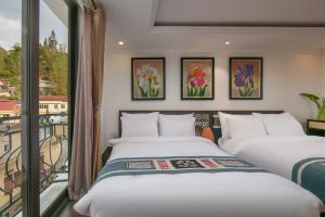 Postel nebo postele na pokoji v ubytování Quiet Sapa Hotel