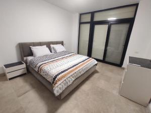 a bedroom with a bed and a large window at 3bedroom chalet swan lake North coast- 388B in Zāwiyat al ‘Awwāmah