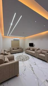 a living room with two couches and a television at شقة بأثاث فُندقي in Al Madinah