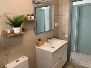 a bathroom with a sink and a mirror and a toilet at Casa Valle del Turia in Chulilla +43 photos