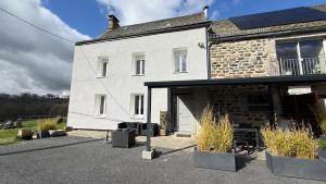 a white house with solar panels on the side of it at Fontanies en Aubrac in Laguiole