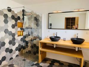 a bathroom with two sinks and a mirror at Alice Cottage in Cléder +38 photos