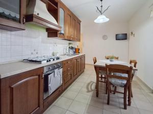 a kitchen with a table and a stove top oven at Le stanze di NinFa in Pacentro