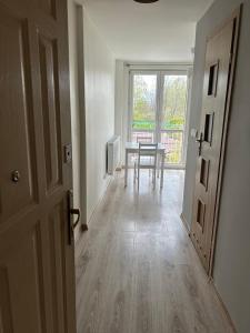 an empty room with a table and a window at Apartament Lazurowy in Puck