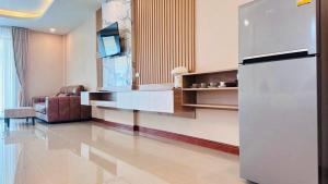 a living room with a refrigerator and a couch at Colour Beach Resort in Ban Ro