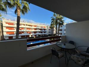 a balcony with a table and chairs and a building at El Rincon in Alicante