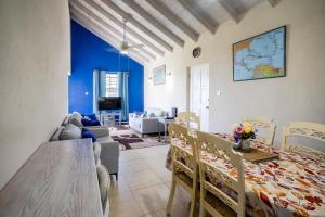 a living room with a table and chairs and a dining room at Best E Villas Providence Ch Ch in Christ Church