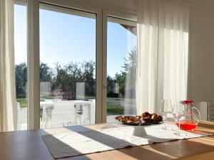 a table with a plate of food and wine glasses at Casetta Ortica in Montemaggiore al Metauro