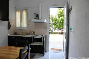 A kitchen or kitchenette at Rentoulia Apartments