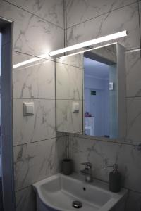 a bathroom with a sink and a mirror at Fotini's studio in Paleo Tsifliki +21 photos