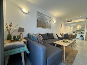 a living room with a blue couch and a table at El Rincon in Alicante