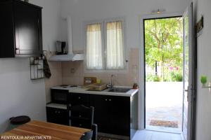A kitchen or kitchenette at Rentoulia Apartments