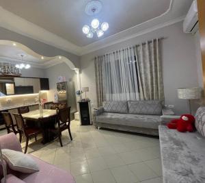 a living room with a couch and a table at Oaz Guest House Durres in Durrës