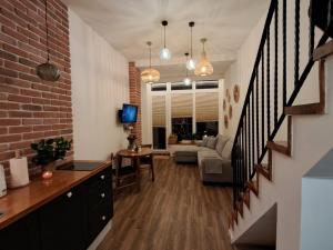 a living room with a staircase and a brick wall at Jarzębinka in Ustroń