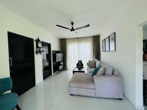 ein Wohnzimmer mit Couch und Fernseher in der Unterkunft The Divines Edge in Hikkaduwa