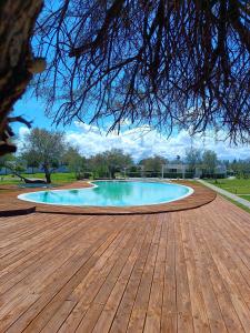 a swimming pool on a wooden deck at Spiaggiabella Resort in Torre Rinalda